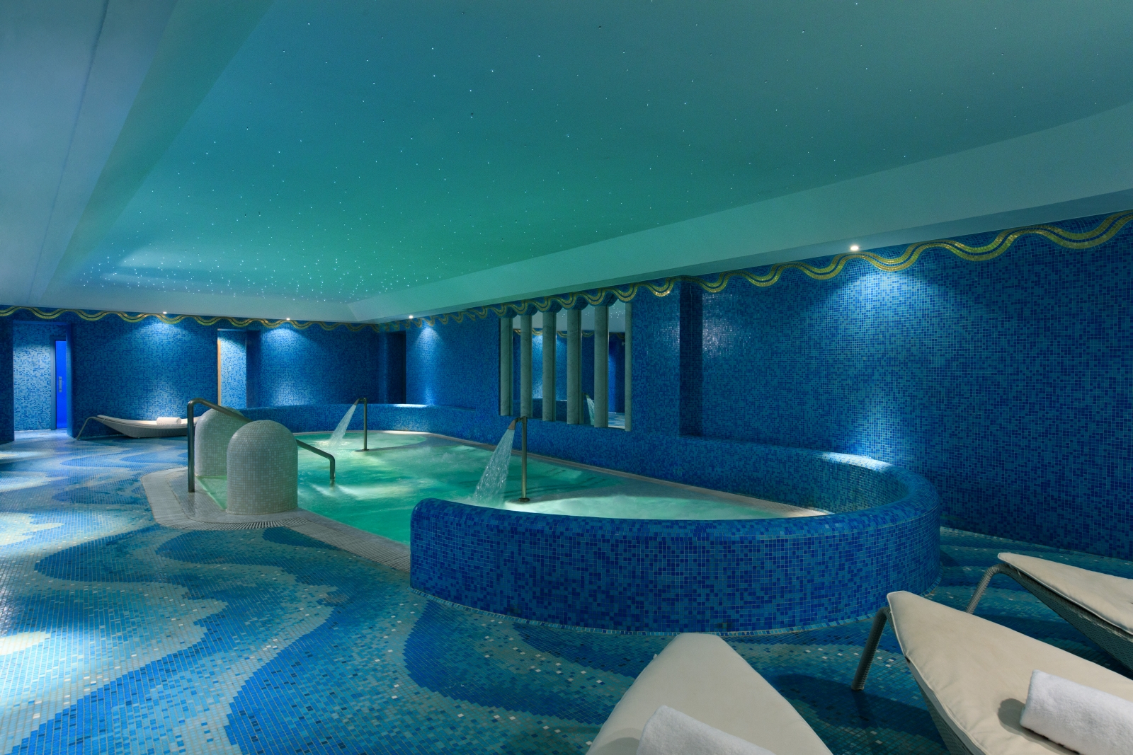 Indoor pool and loungers at Hotel de Russie, luxury hotel in Rome, Italy