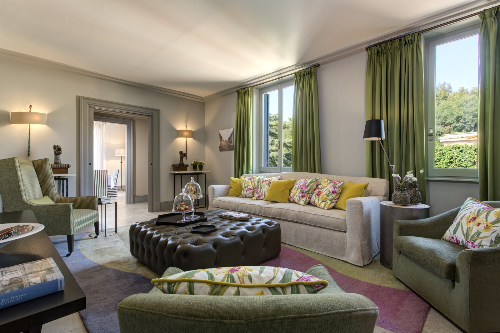 Comfortable sitting room of a Nijinsky suite with views over the garden at Hotel de Russie, luxury hotel in Rome, Italy