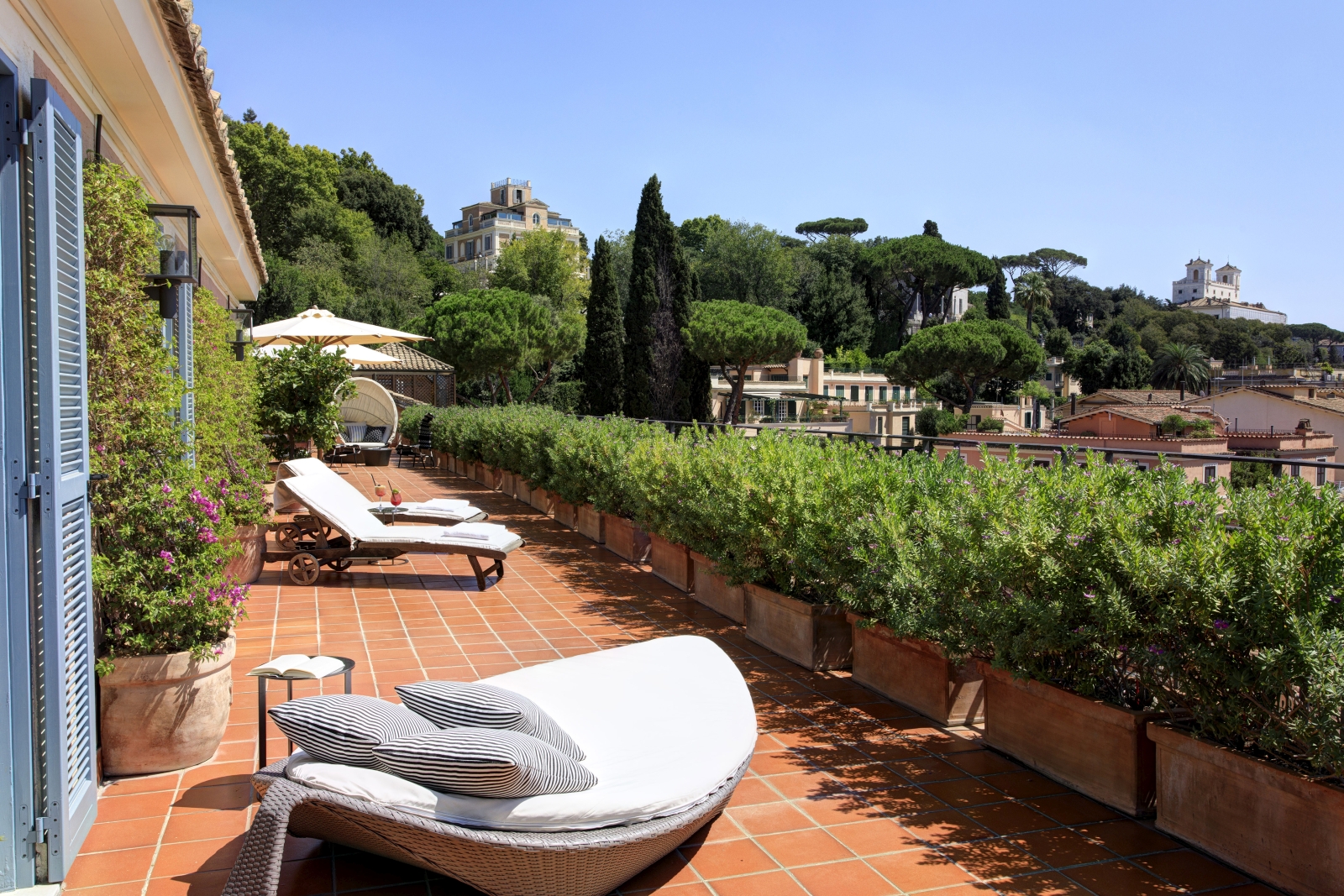 Terrace and loungers of a Nijinsky Suite at Hotel de Russie, luxury hotel in Rome, Italy
