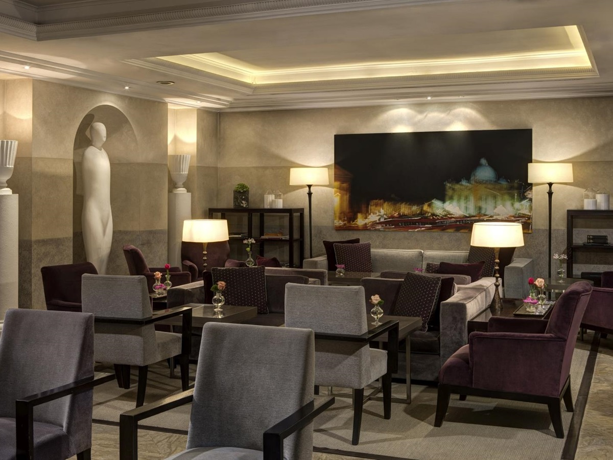 Sitting area of the Stravinskij Bar with minimalistic design and artwork at Hotel de Russie, luxury hotel in Rome, Italy