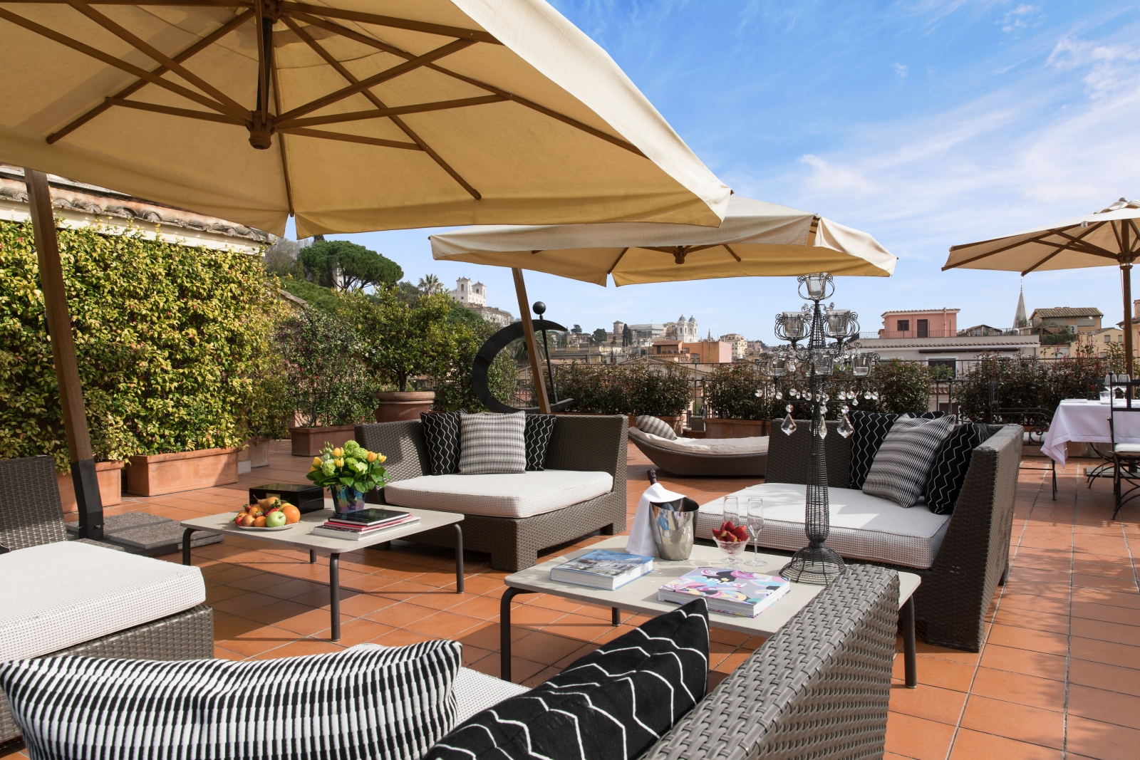 Terrace with plenty of seating and parasols at at Hotel de Russie, luxury hotel in Rome, Italy