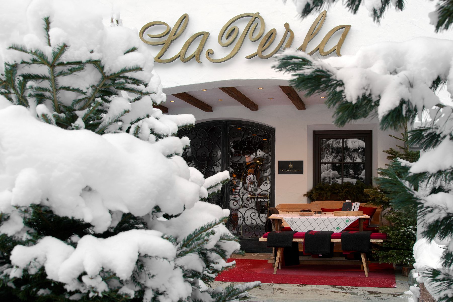 Exterior view of Hotel La Perla in Corvara in the snow.