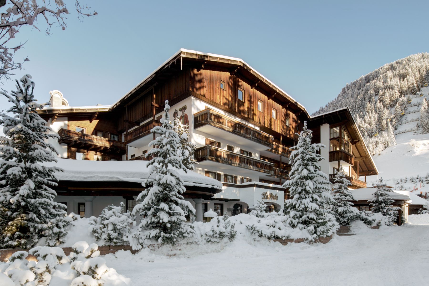 Exterior view of Hotel La Perla during winter in Corvara