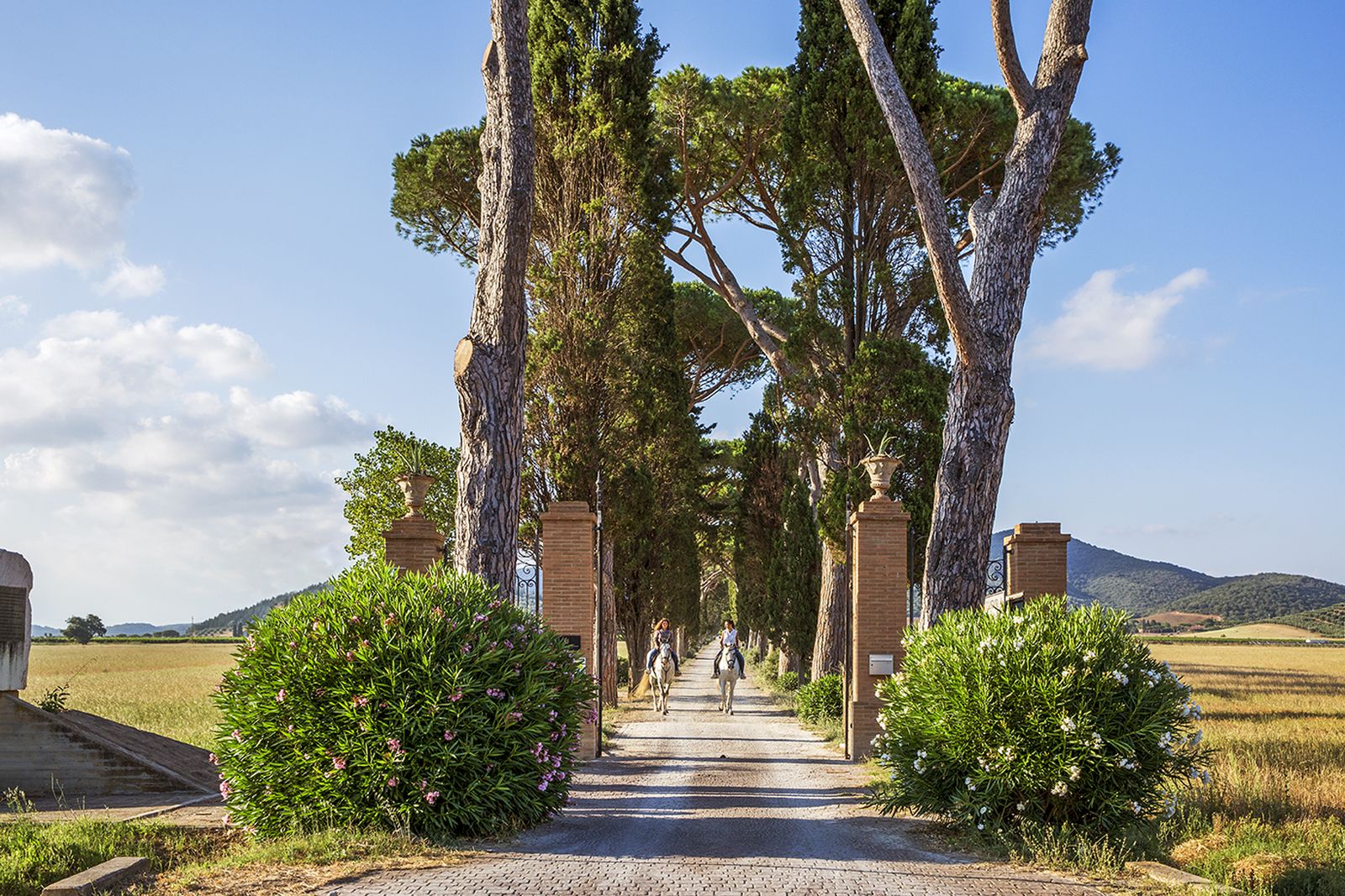 Guests horse riding in the countryside surrounding Hotel L'Andana in Tuscany
