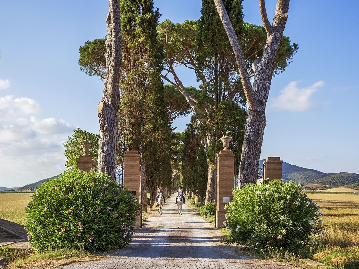 Guests horse riding in the countryside surrounding Hotel L'Andana in Tuscany