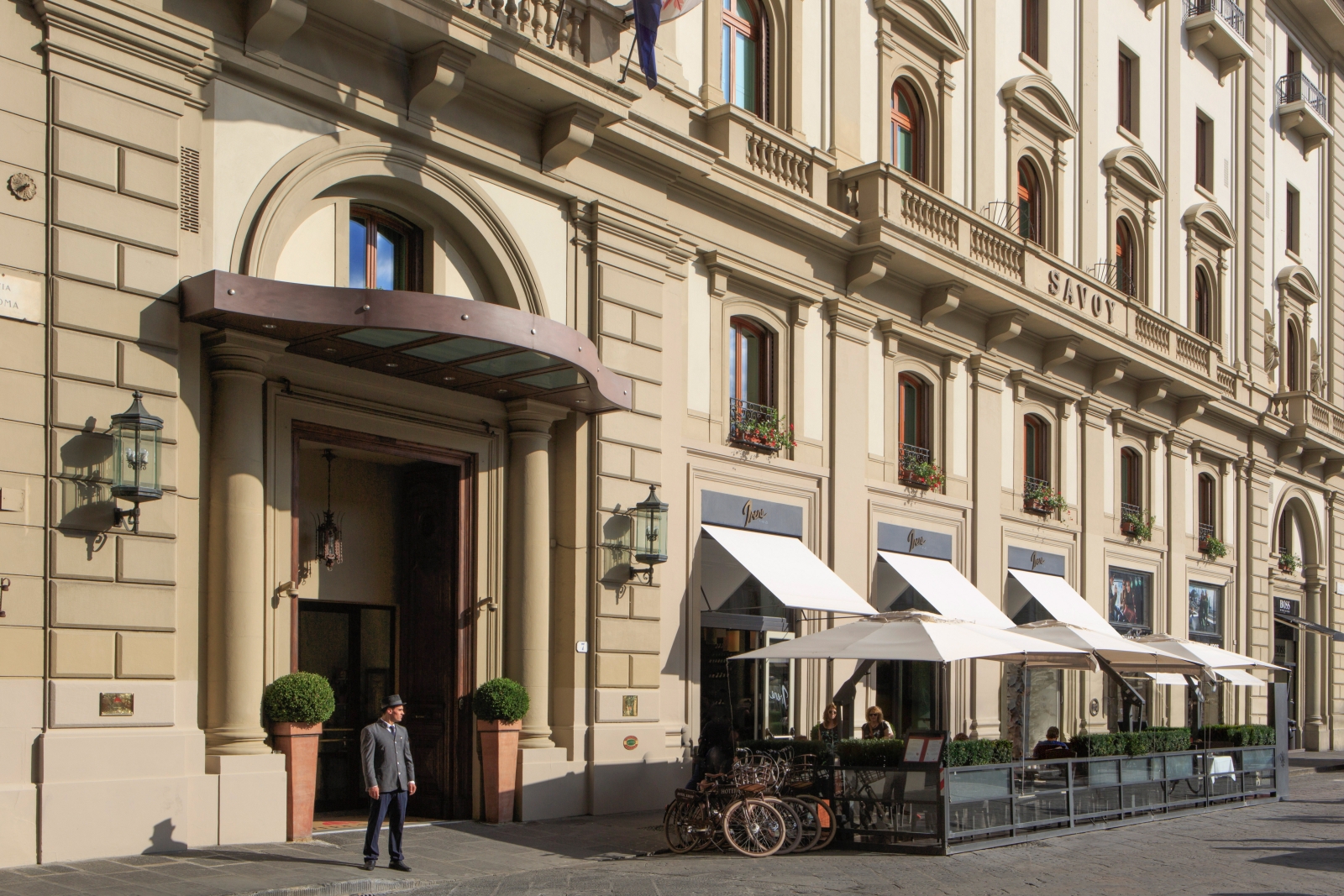 Exterior of Hotel Savoy with tables of Irene restaurant outside