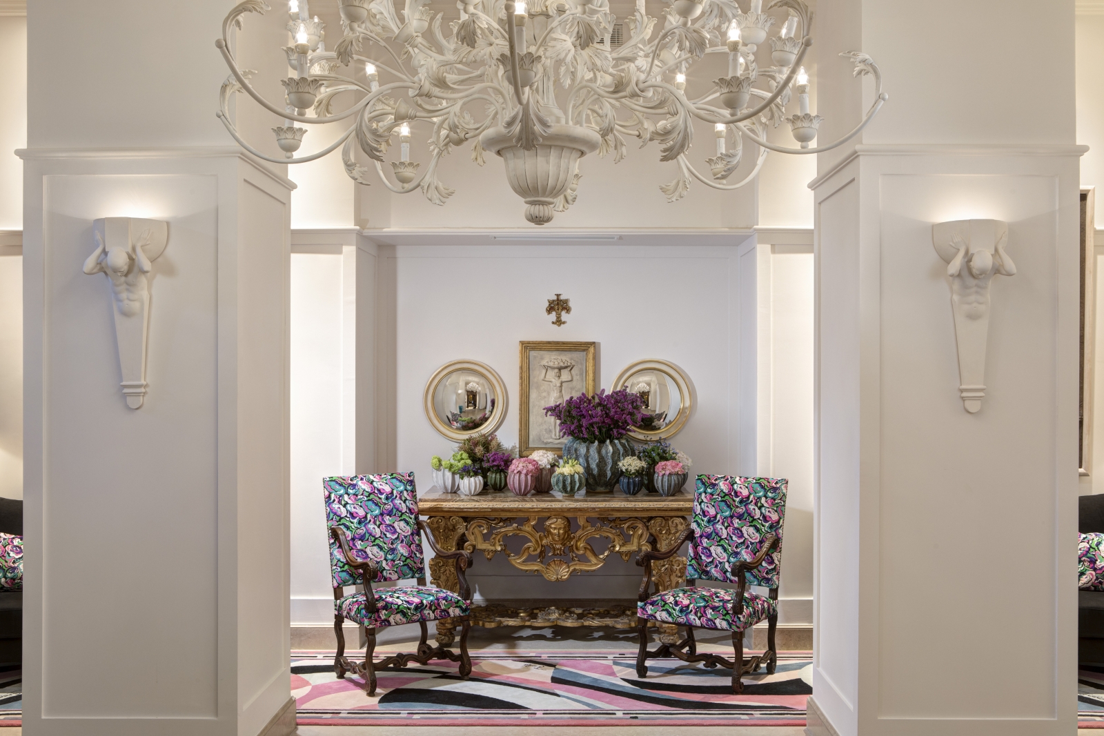 Lobby with chandelier and feature chairs at Hotel Savoy, a luxury hotel in Florence, Italy