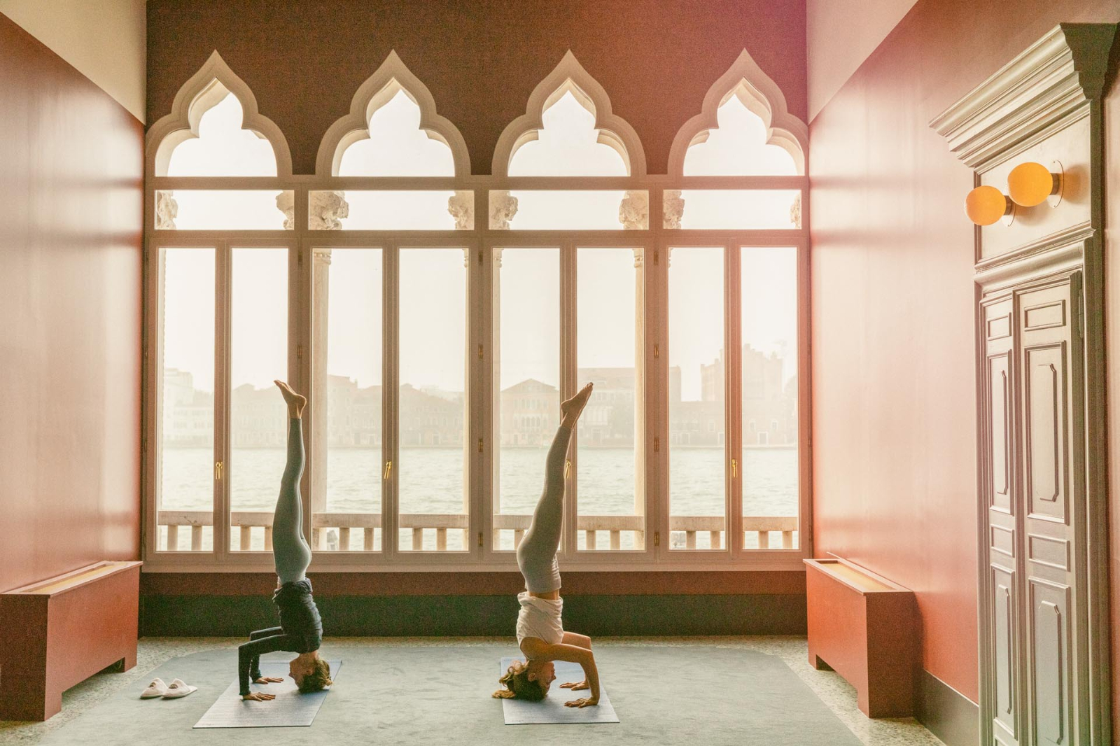Guests practising yoga overlooking the canal at Il Palazzo Experimental in Venice