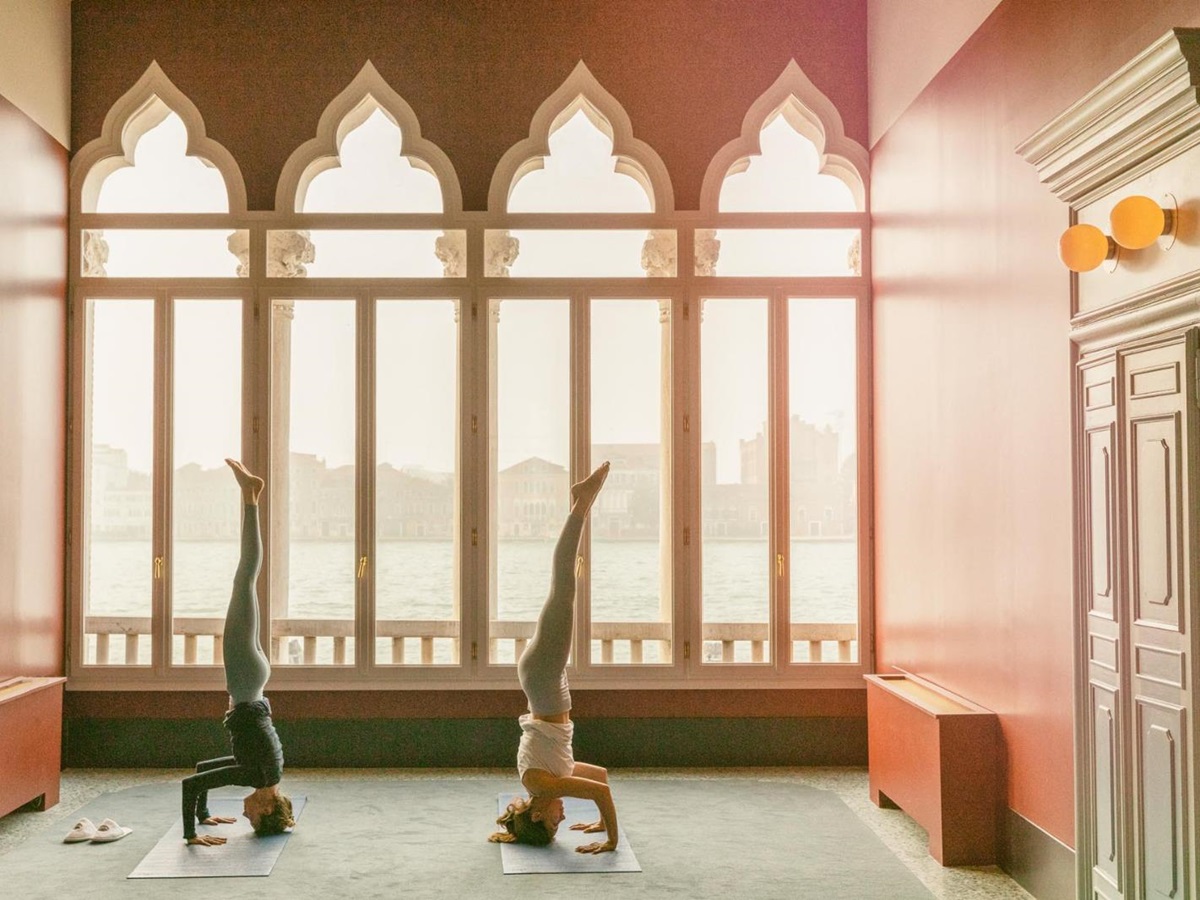Guests practising yoga overlooking the canal at Il Palazzo Experimental in Venice