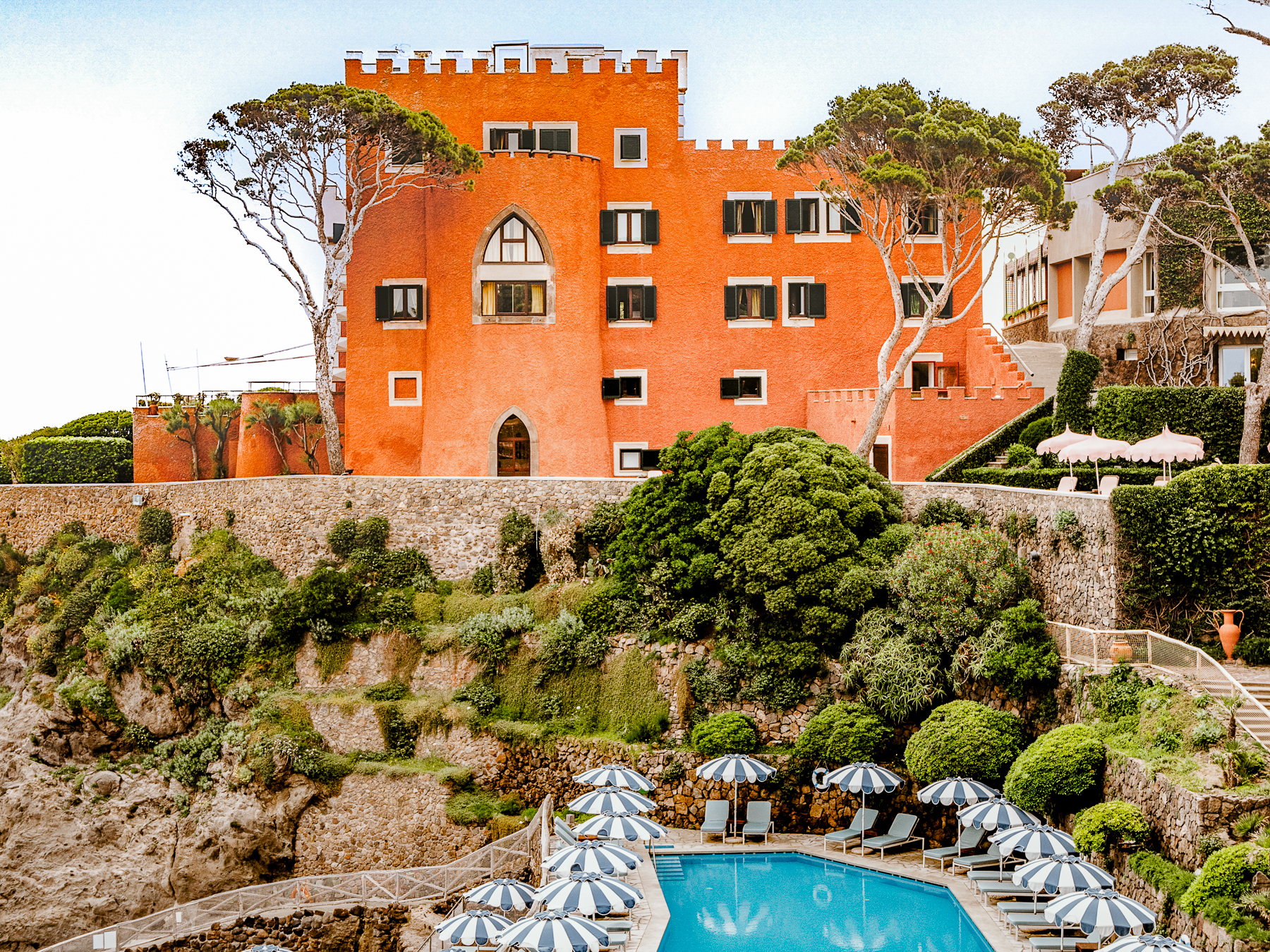 Facade of the hotel and swimming pool area at Il Pellicano in Italy