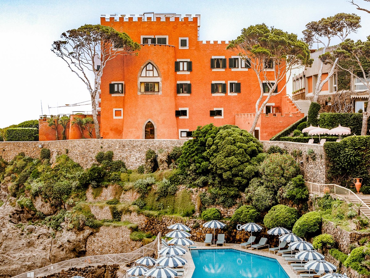 Facade of the hotel and swimming pool area at Il Pellicano in Italy