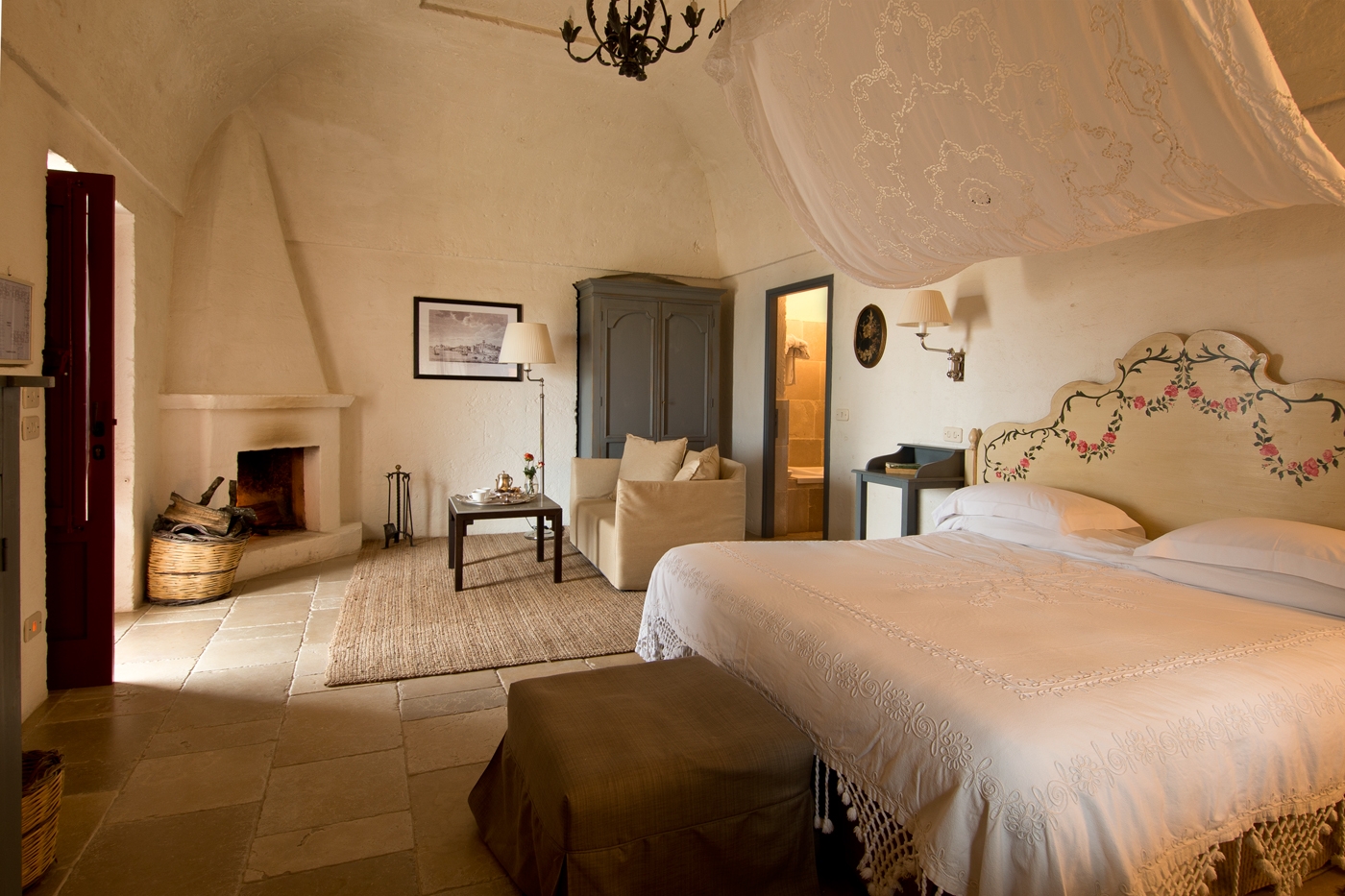 Junior Suite at luxury hotel Masseria Torre Coccaro in Italy with fireplace and seating area