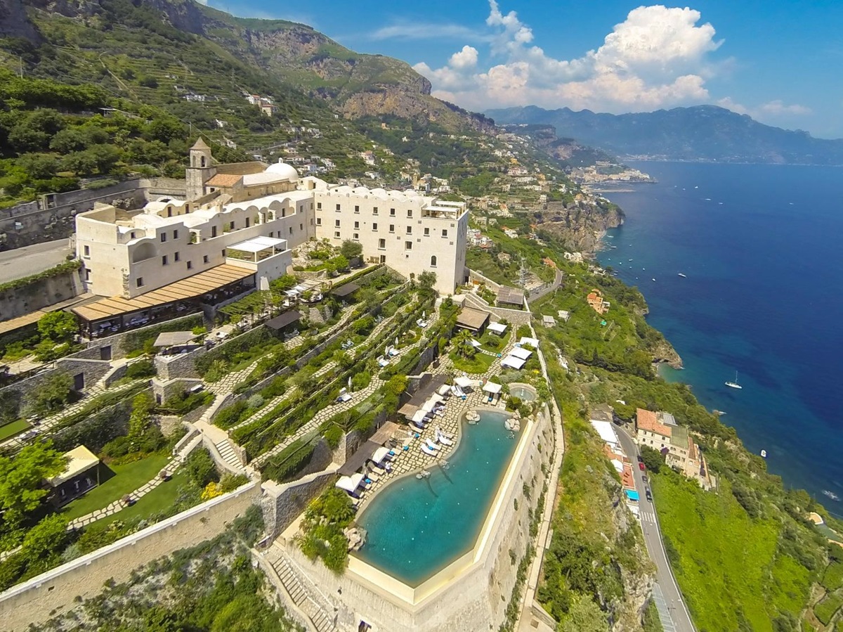 Aerial view of Monastera Santa Rosa, its pool and gardens overlooking the Mediterranean