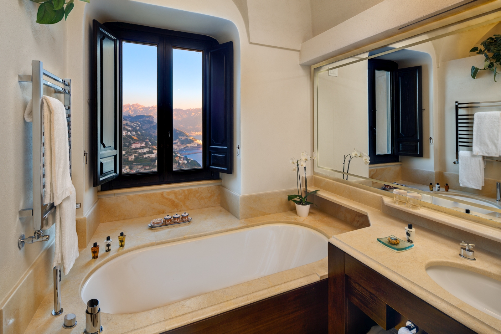 Bathroom with tub overlooking the surrounding hills and villages at Monastera Santa Rosa, luxury hotel in Italy