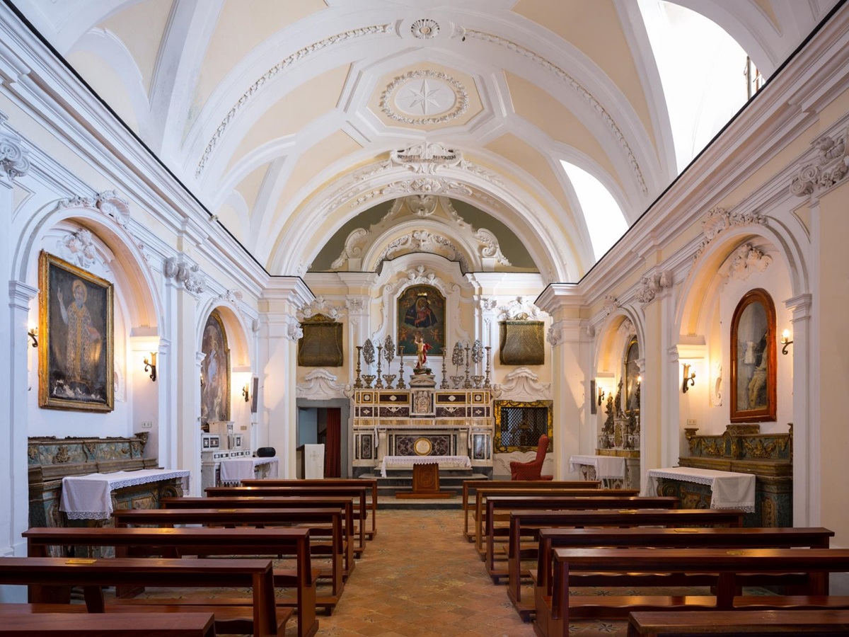 Interior of the Catholic church with art and lavish decorations at Monastera Santa Rosa, luxury hotel in Italy
