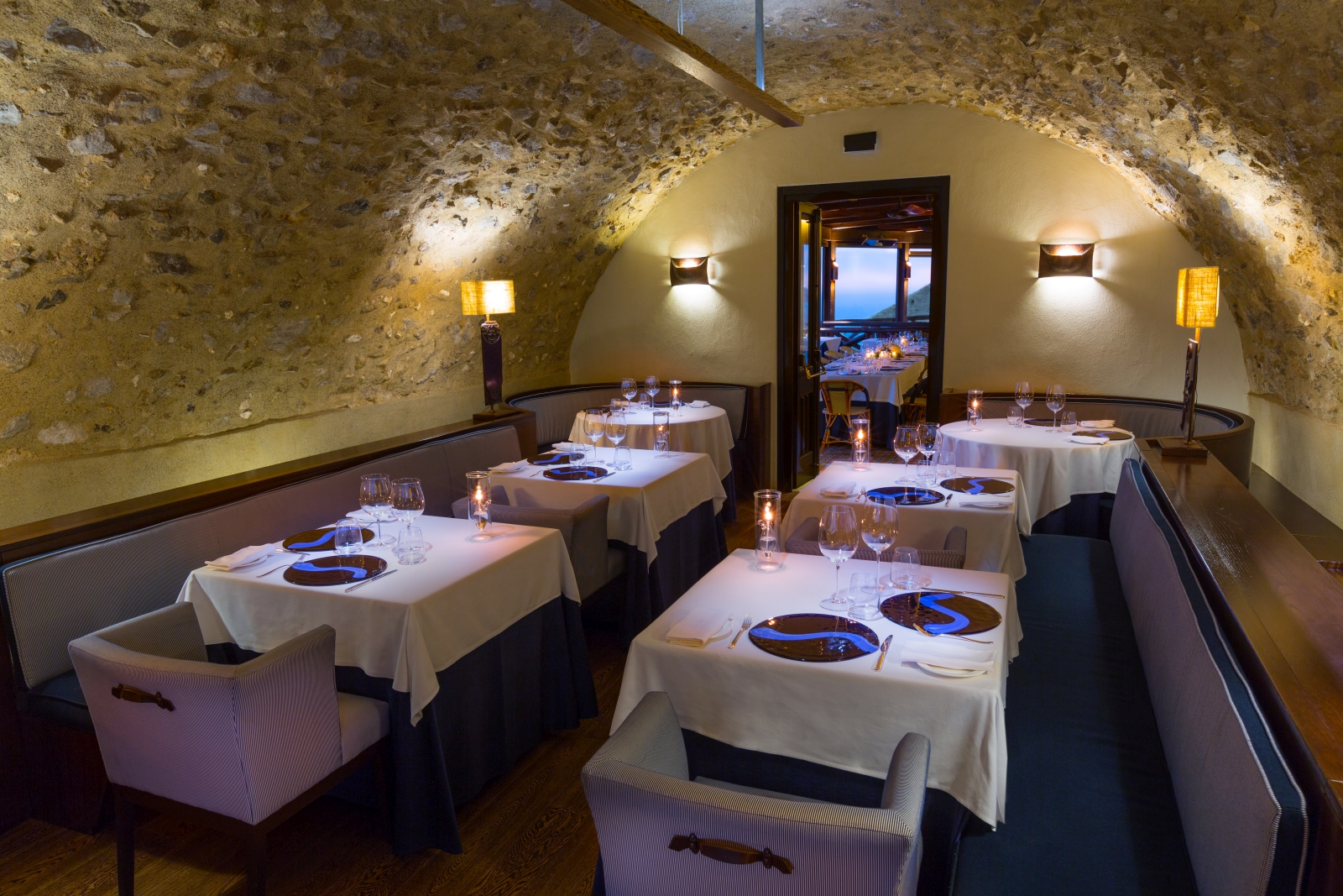 Small dining room in a natural stone room at Monastera Santa Rosa, luxury hotel in Italy