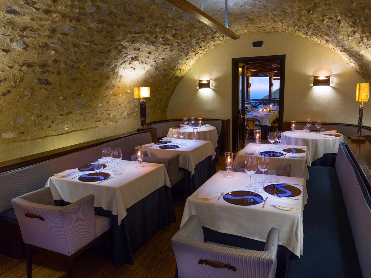 Small dining room in a natural stone room at Monastera Santa Rosa, luxury hotel in Italy