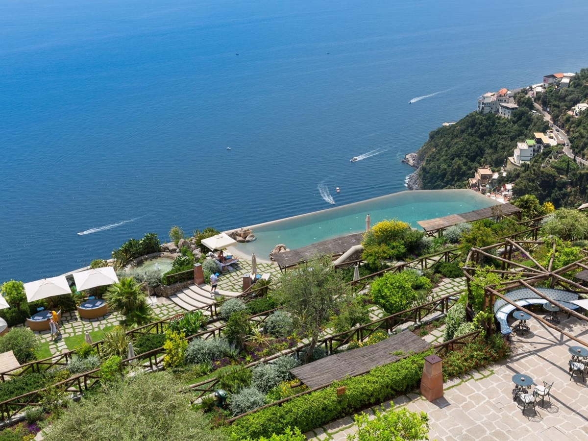Overlooking the gardens and infinity pool down to the Mediterranean Sea at Monastera Santa Rosa, luxury hotel in Italy