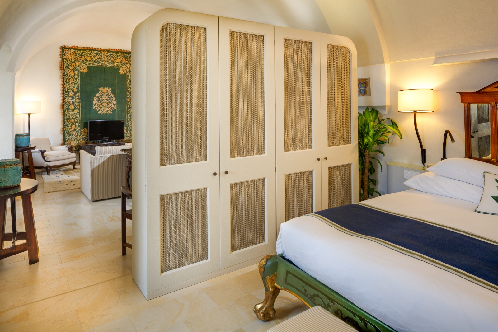 Junior Suite with private sitting area with an earthen toned colour palette at Monastera Santa Rosa, luxury hotel in Italy