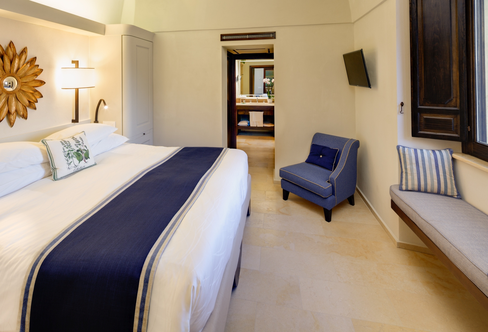 Double bedroom with wooden shutters at Monastera Santa Rosa, luxury hotel in Italy
