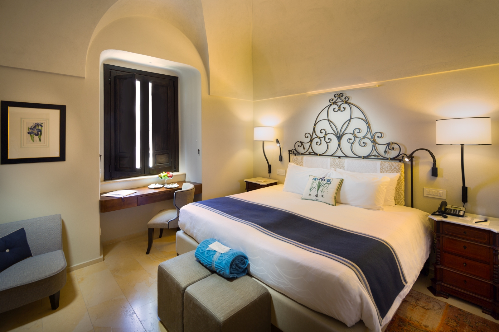 Double room with shutter windows and iron cast head board at Monastera Santa Rosa, luxury hotel in Italy