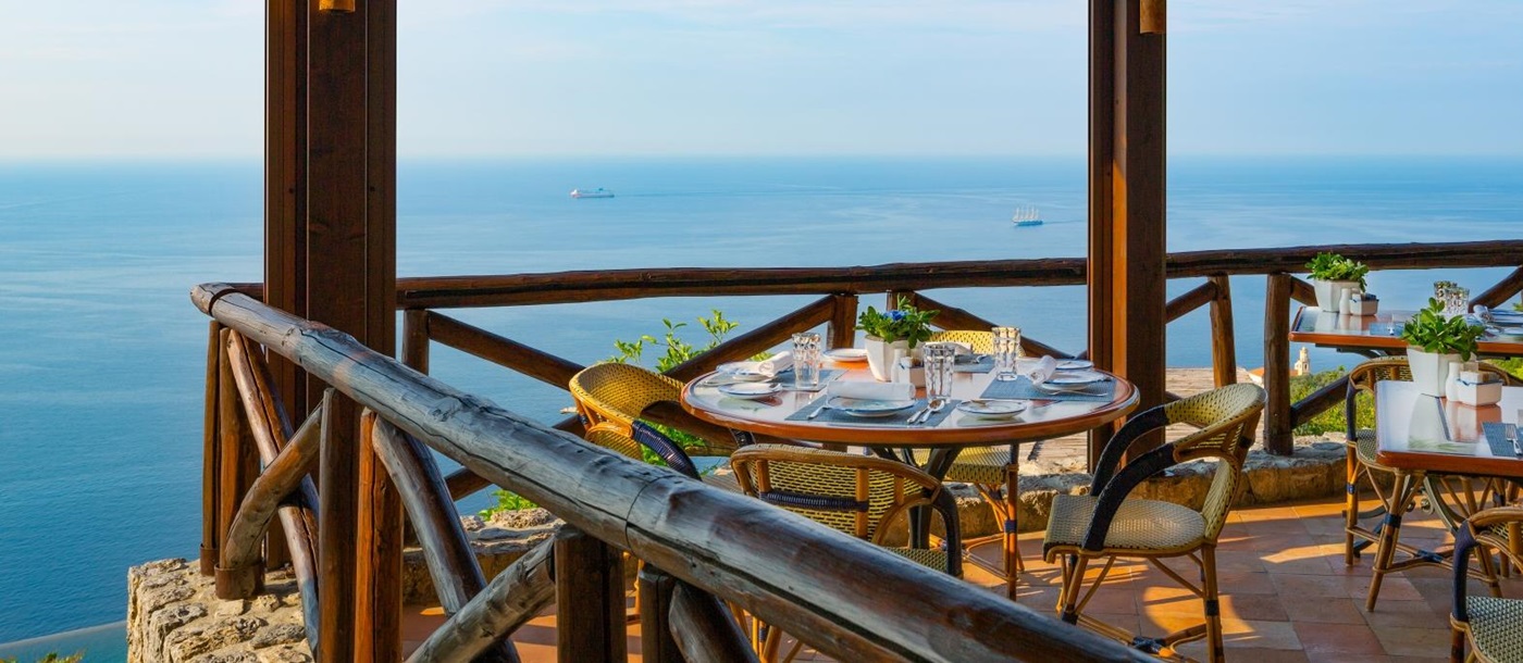 Terrace dining, overlooking the Mediterranean Sea at Monastera Santa Rosa, luxury hotel in Italy