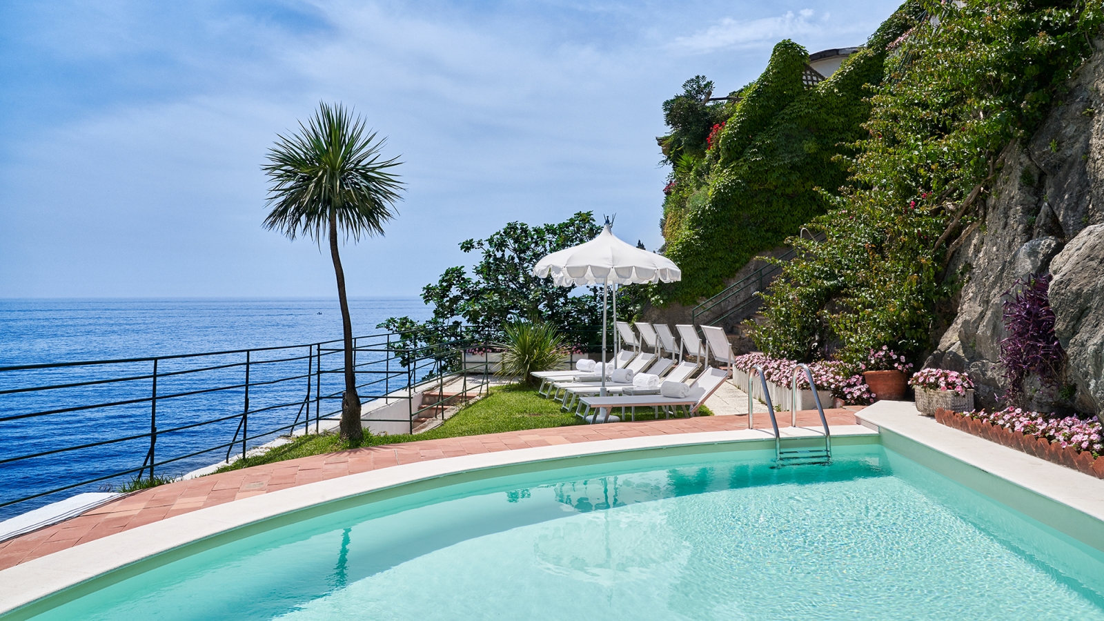 Loungers and pool at the Beach Club of Palazzo Avino, luxury hotel in Italy