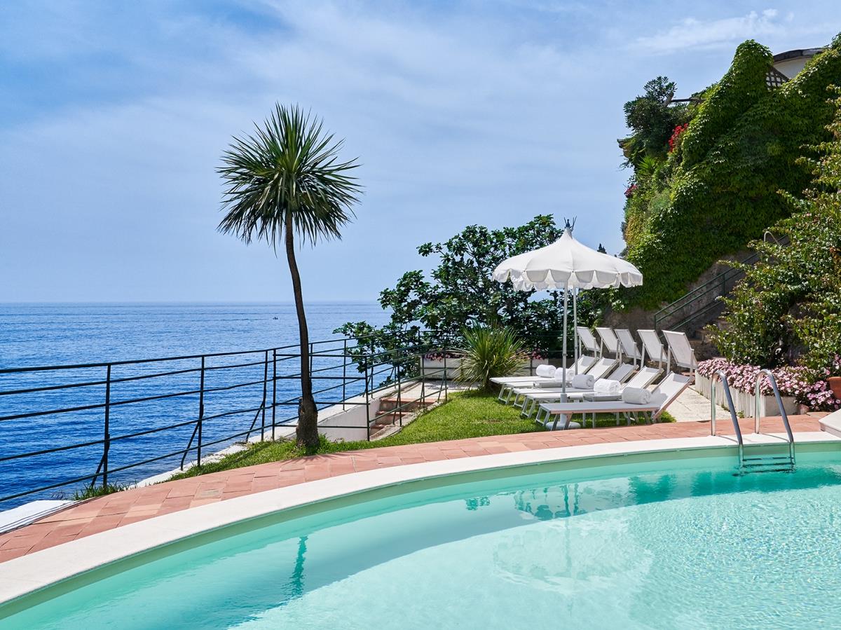 Loungers and pool at the Beach Club of Palazzo Avino, luxury hotel in Italy