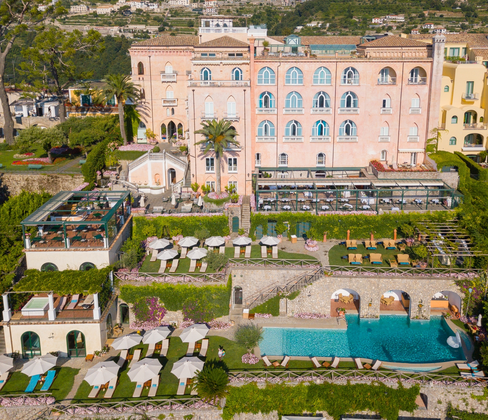 Aerial view of Palazzo Avino, its lush gardens and pool, terrace dining and sun loungers