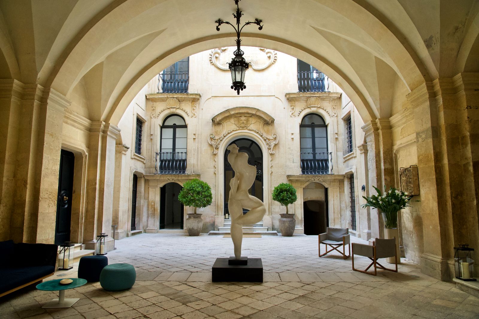 White marble sculpture in the courtyard of luxury hotel Palazzo Bozzi Corso in Lecce, Italy