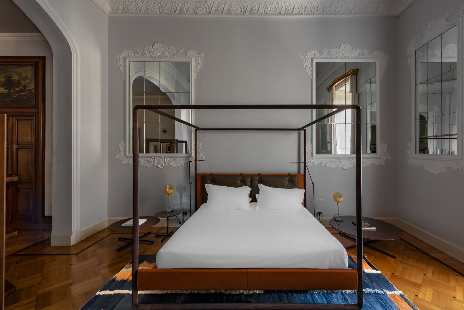 Four-poster bed of the Mirrors Suite at luxury hotel Palazzo Bozzi Corso in Lecce, Italy