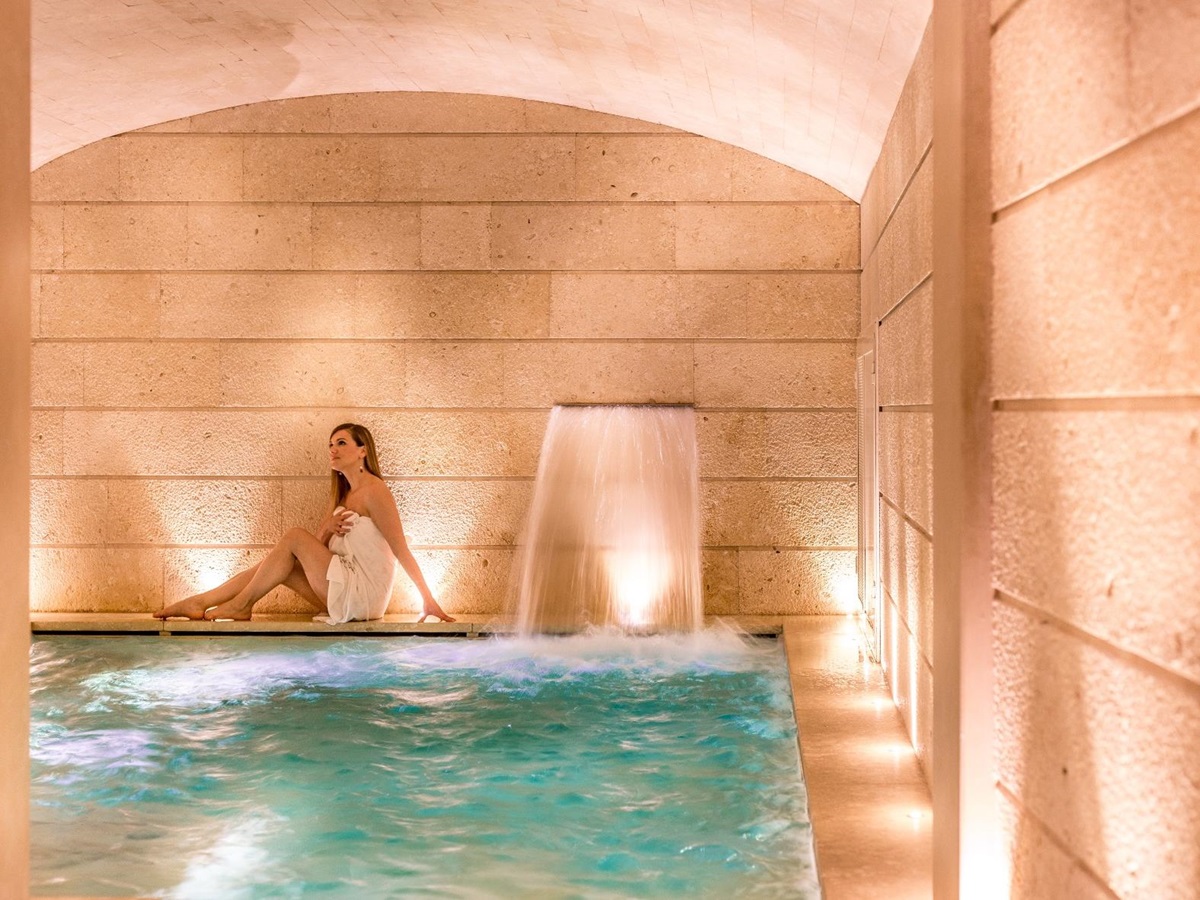 Woman sitting in the spa of Palazzo Gattini, Italy