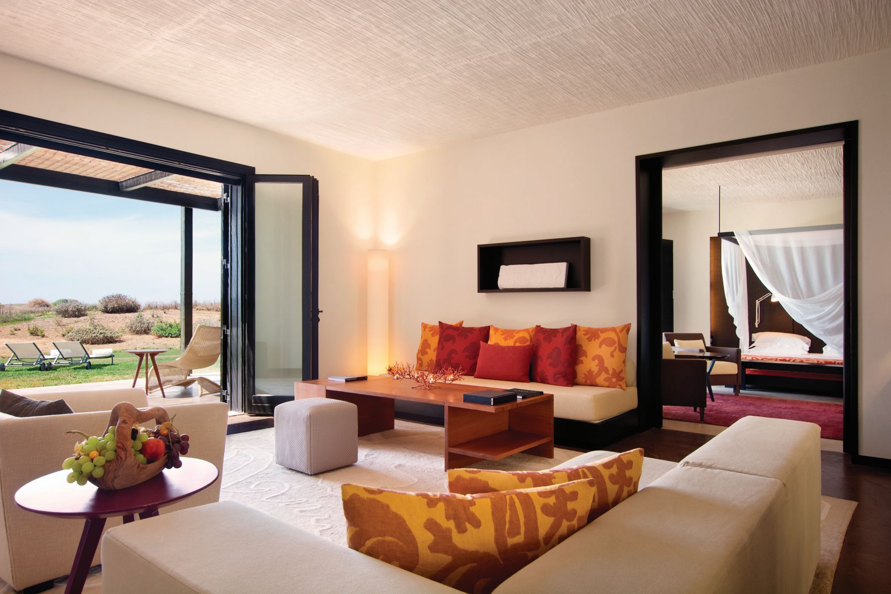 Ambassador Suite at Verdura Resort - a Rocco Forte Hotel, with view of living room with FRench windows onto gardens