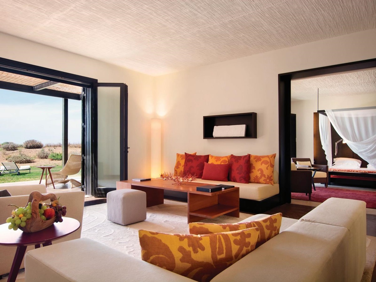 Ambassador Suite at Verdura Resort - a Rocco Forte Hotel, with view of living room with FRench windows onto gardens