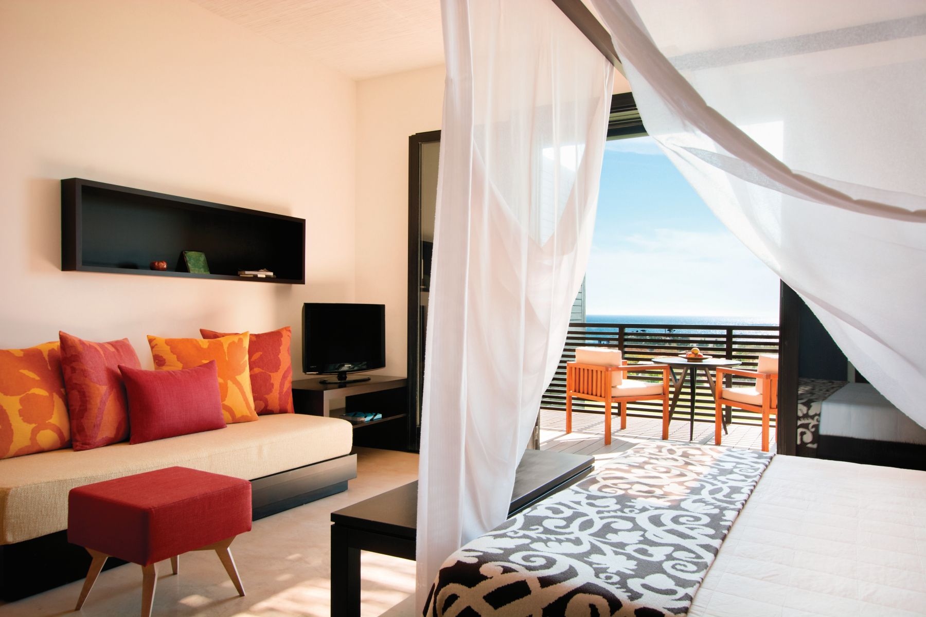 A Deluxe Room with French windowd open onto gardens at Rocco Forte Verdura Resort