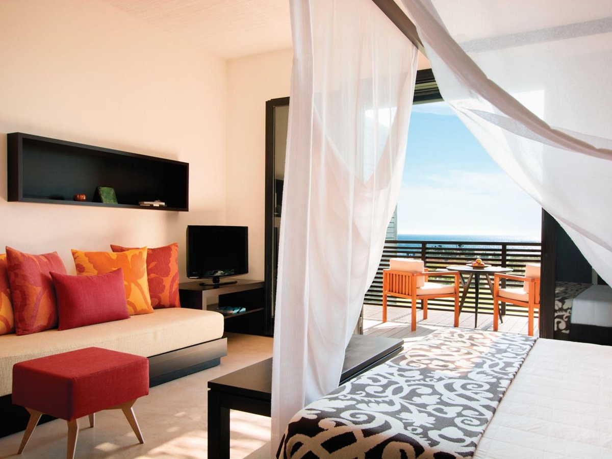 A Deluxe Room with French windowd open onto gardens at Rocco Forte Verdura Resort