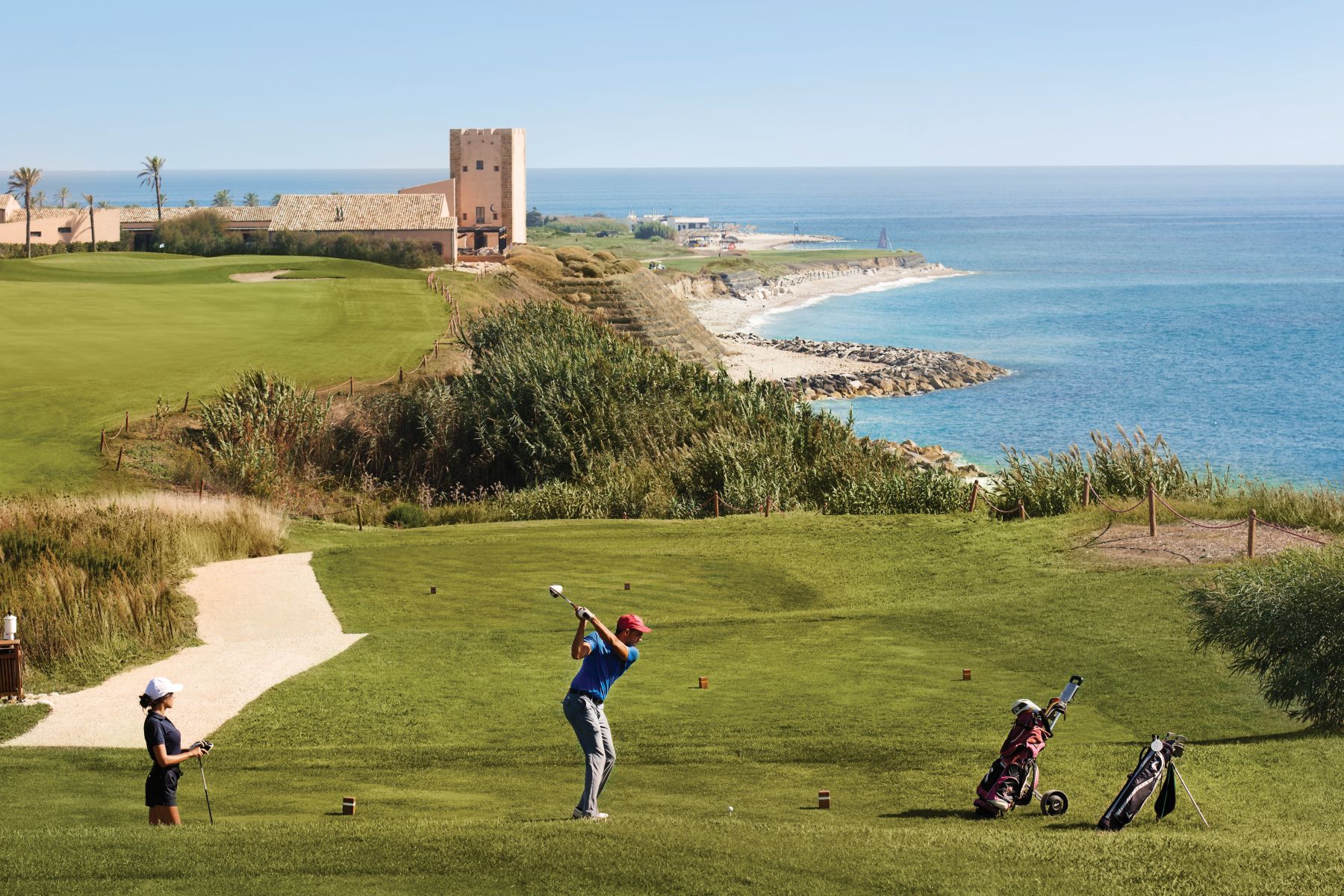 Golfers playing on the links golf course at Rocco Forte Verdura Resort in Sicily
