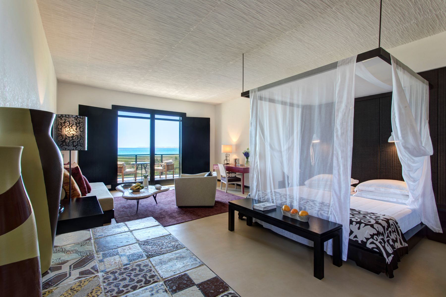 Junior Suite at Rocco Forte Verdura Resort in Sicily. Four-poster bed and French windows onto terrace