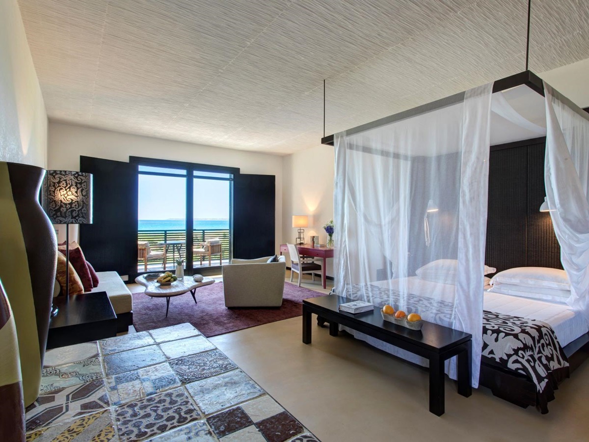 Junior Suite at Rocco Forte Verdura Resort in Sicily. Four-poster bed and French windows onto terrace