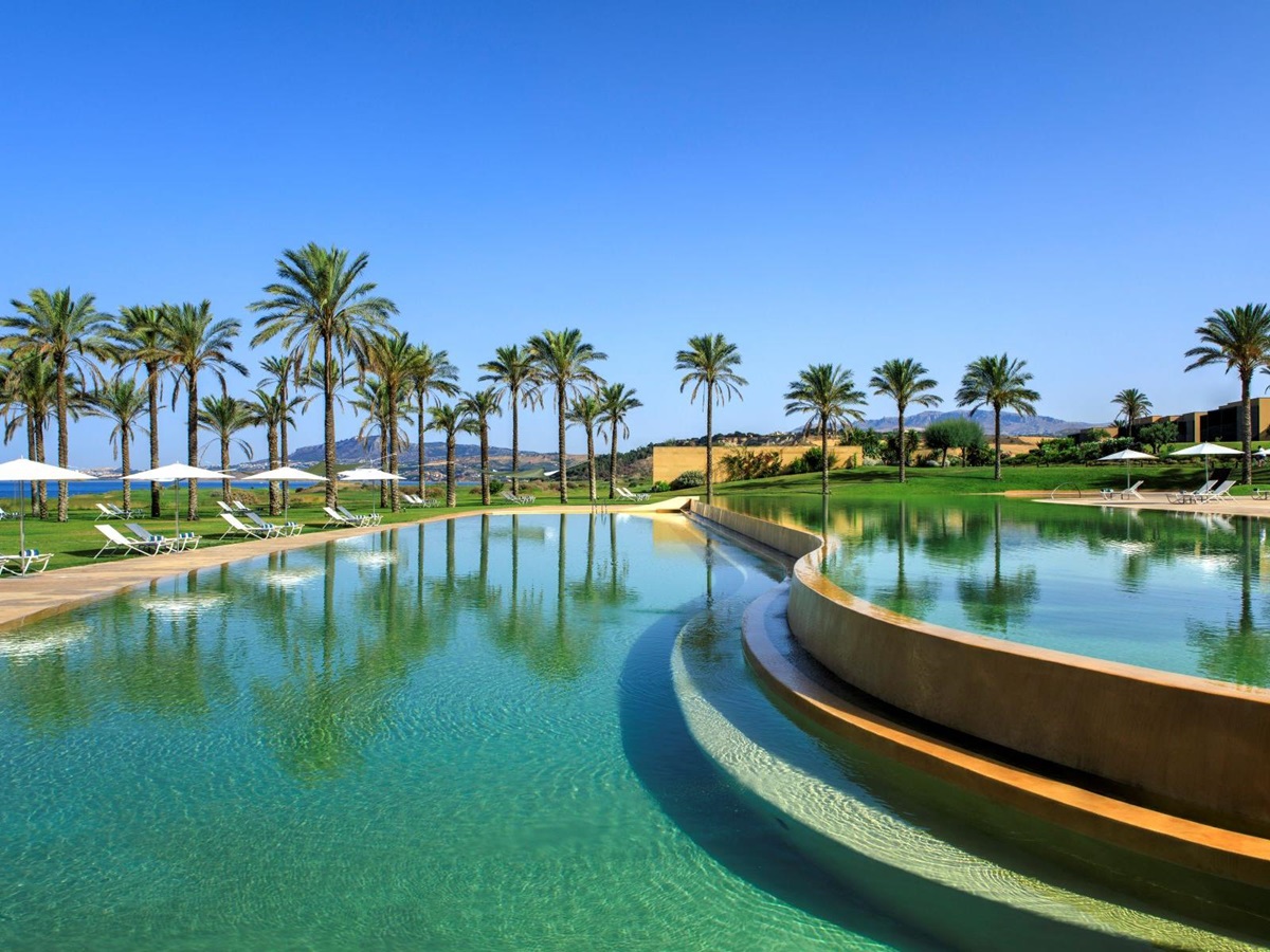 View across large swimming pool at Rocco Forte Verdura Resort in Sicily