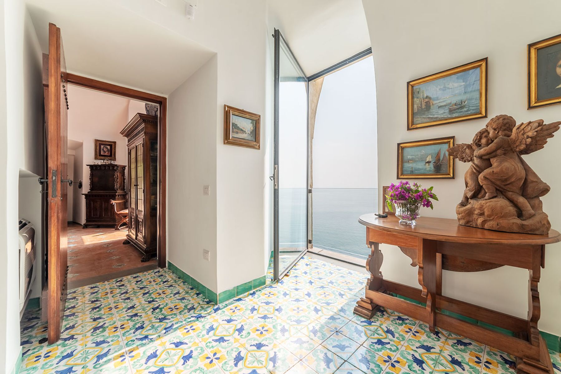 View of the corridor with tiled floors and an open terrace at Castello Sul Mare in Amalfi