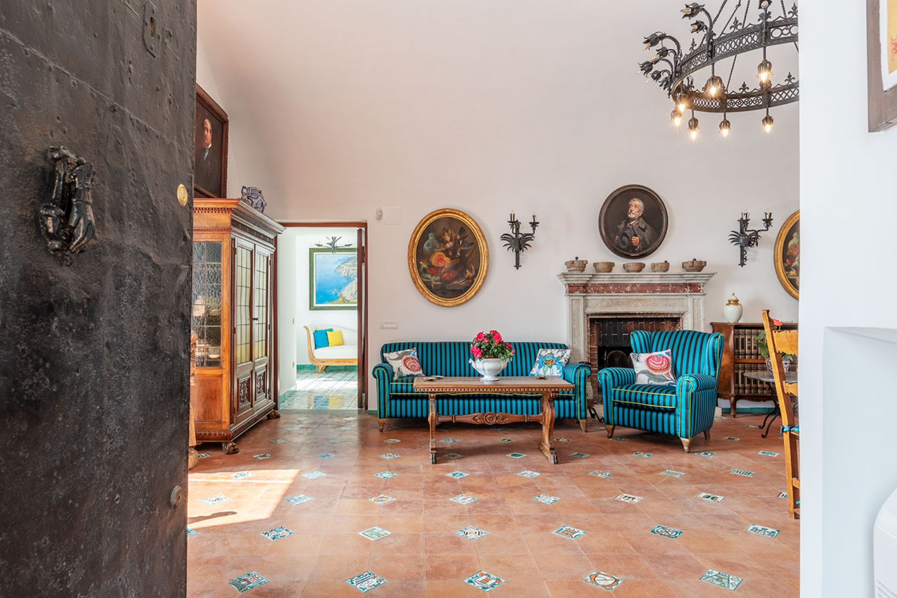 Living room with striped sofas and tiled flooring at Castello Sul Mare in Amalfi