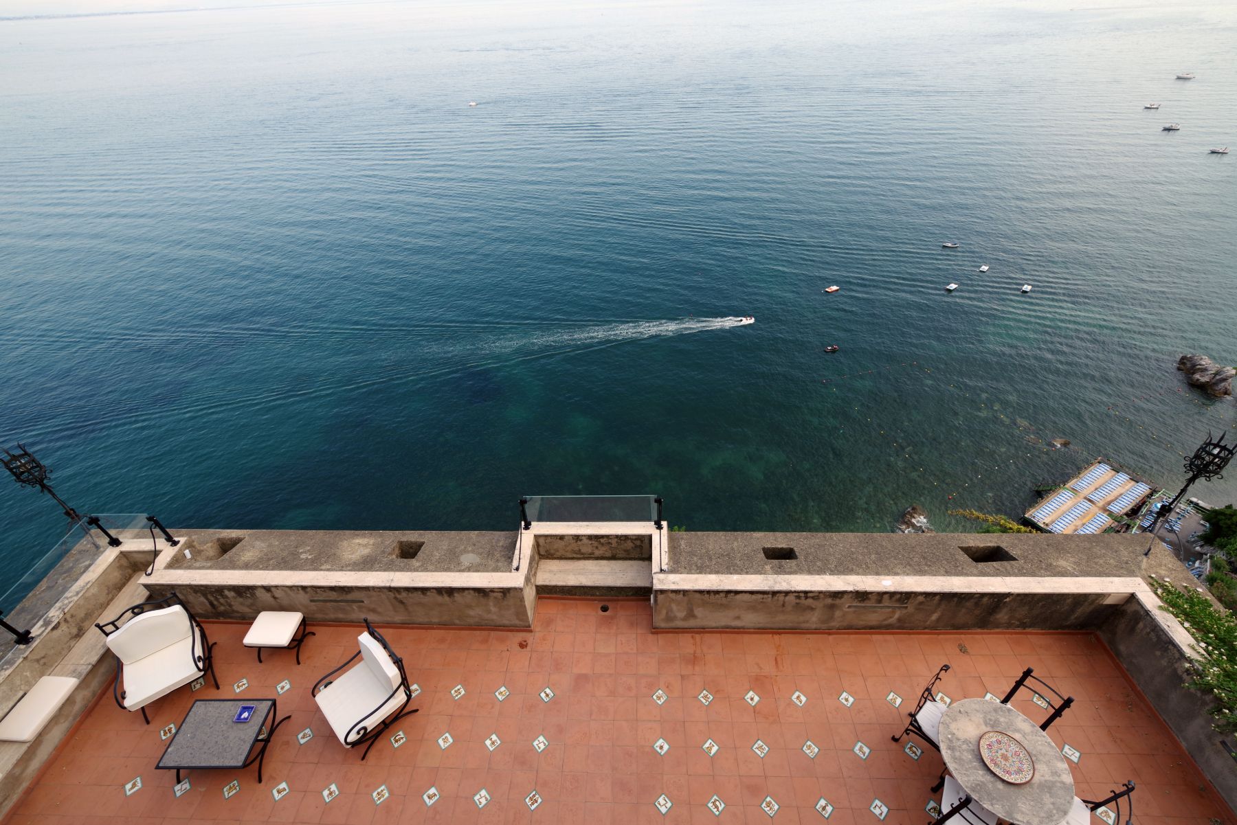 Overhead view of the outdoor terrace at Castello Sul Mare overlooking the sea and beaches in Amalfi