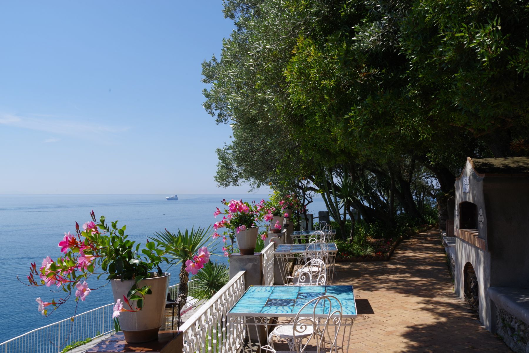 Outdoor terrace with breakfast tables overlooking the sea in Amalfi at Castello Sul Mare
