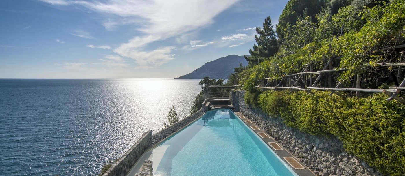 Pool with stone walls and sea view at Il Marinaio on the Amalfi Coast in Italy