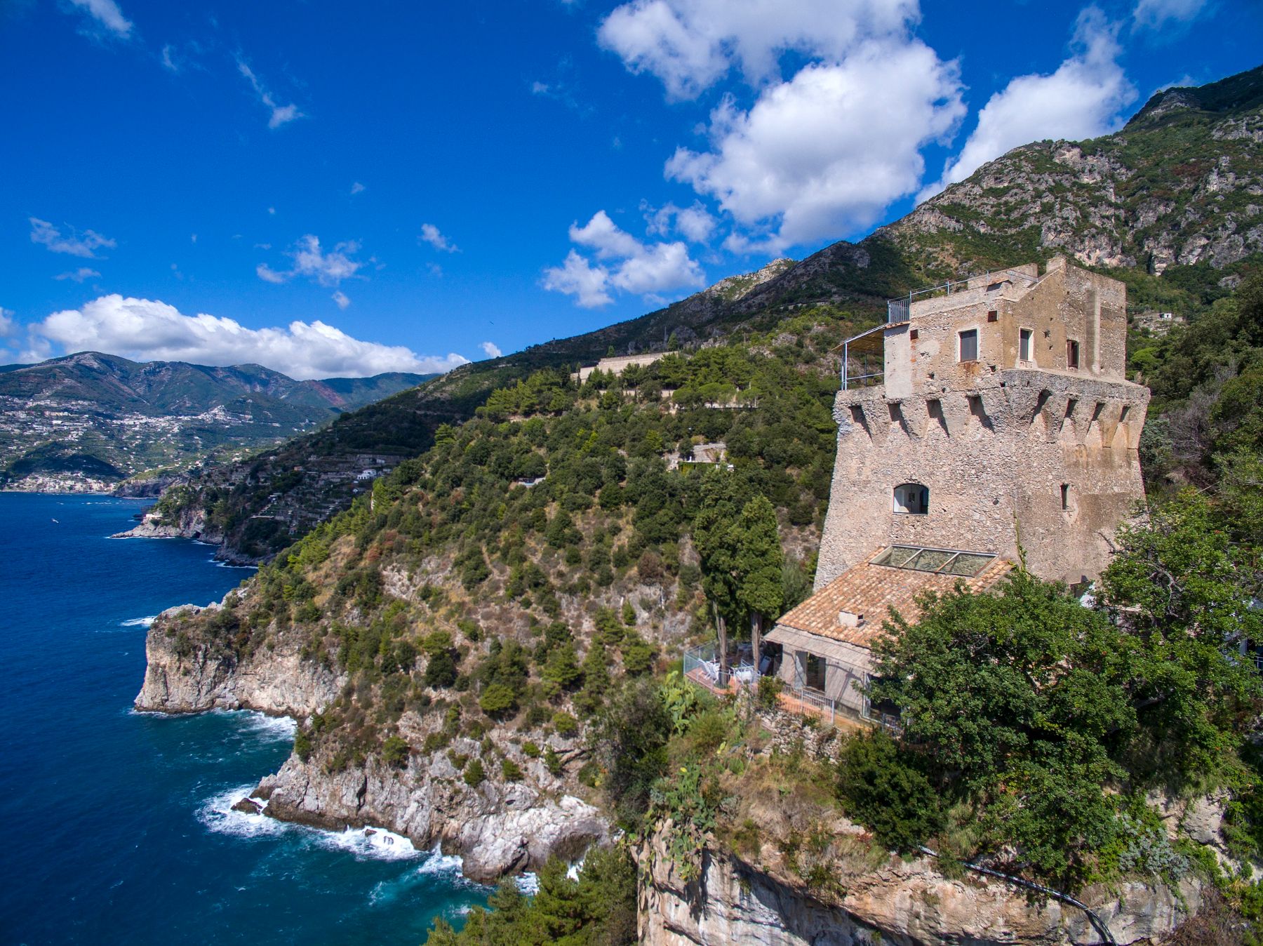 Aerial shot of tower over the sea at Villa Maiori in the Amalfi Coast, Italy