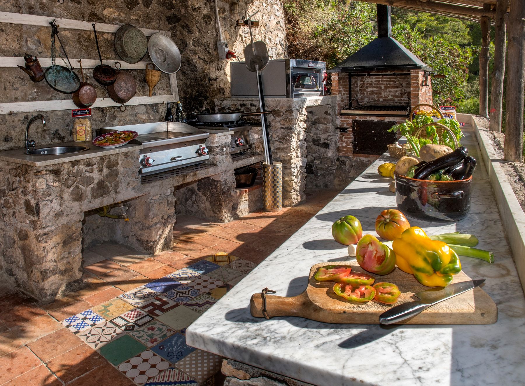 outoor kitchen at Il Marinaio in Amalfi, with stone kitchen surfaces and fresh food on a chopping board
