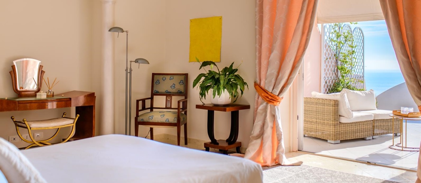 Double bedroom with door onto terrace at Villa Contralto in Amalfi