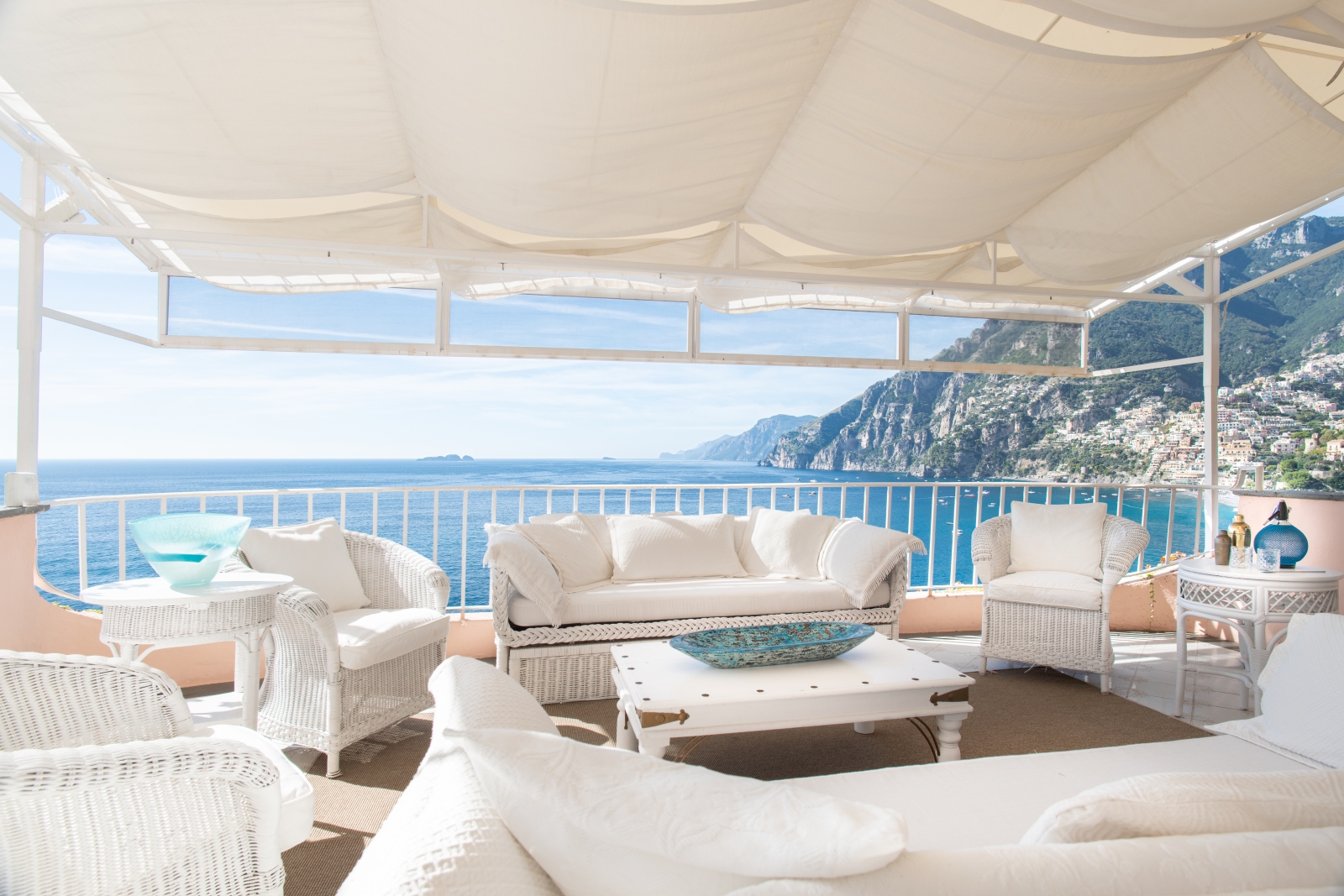 Outdoor seating with white furniture and white cover at Villa Contralto in Amalfi