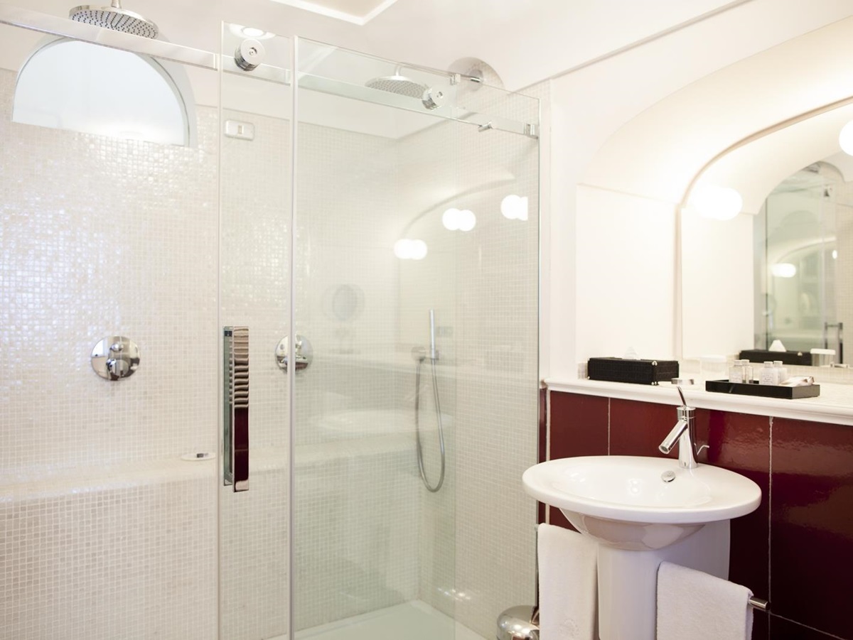 Bathroom with large shower, sink, mirror and window at Villa di Praiano on the Amalfi Coast in Italy